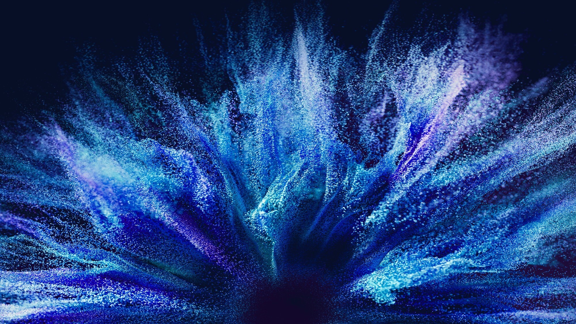 Abstract blue particle explosion resembling energy, data flow or cloud technology.