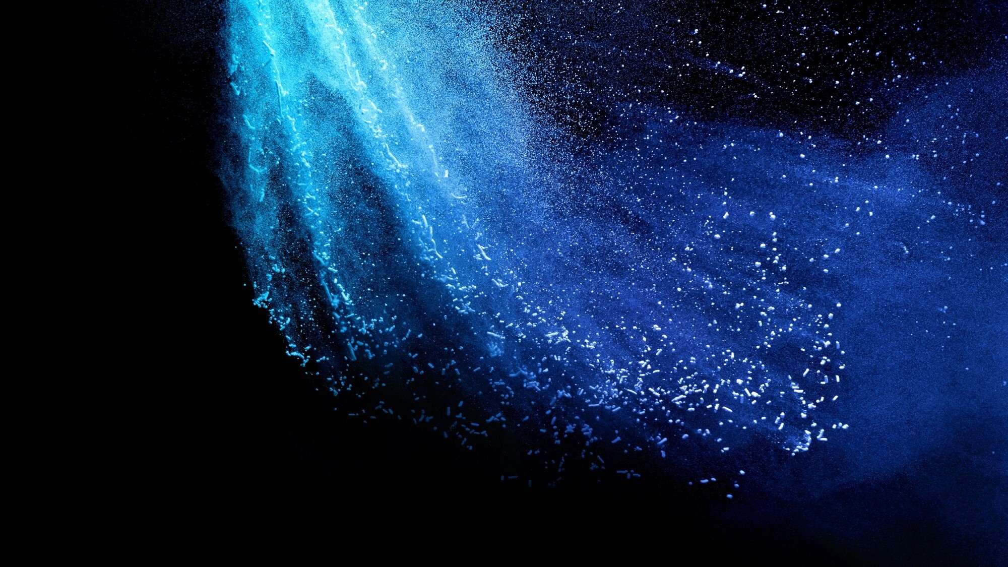 Abstract blue light particles and flowing digital texture on a dark background.